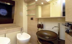 a bathroom with a black sink and a toilet at Azimut in Nesebar