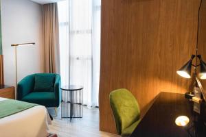 A bed or beds in a room at Ironwood Hotel