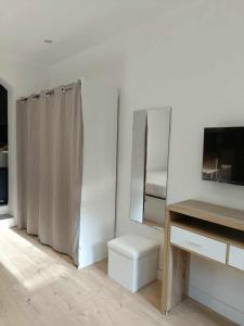 a white room with a mirror and a bed at Appartement studio in Nice +10 photos