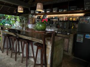 a kitchen with a bar with a watermelon on the counter at LOA Stay in Surigao +25 photos