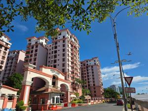 a building on a street with tall buildings at Gee homestay in Kota Kinabalu