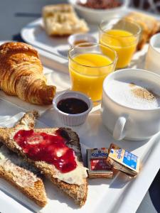a breakfast tray with toast and coffee and orange juice at Premiere Classe Strasbourg Ouest in Strasbourg
