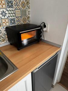 a black toaster oven sitting on top of a counter at Studio Claudia-self Check-in in Brăila +10 photos
