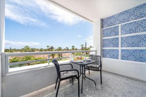 a table and two chairs on a balcony with a view at Holiday Dream near Yumbo in Playa del Ingles +50 photos