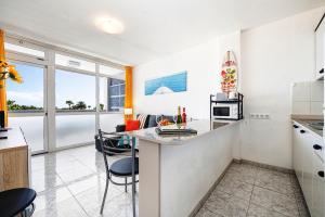 a kitchen with a counter and a kitchen island with a microwave at Holiday Dream near Yumbo in Playa del Ingles