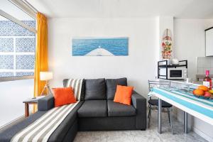 a living room with a couch and a table at Holiday Dream near Yumbo in Playa del Ingles