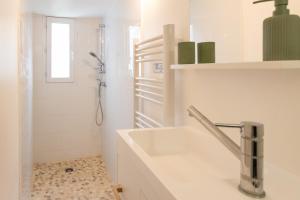a white bathroom with a sink and a shower at Quartier des Théâtres - Hyper Centre - Zen Apparts in Troyes +57 photos