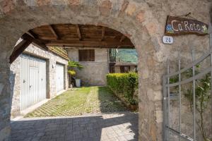 an entrance to a building with an archway at Ca' Rota House Tenno in Tenno