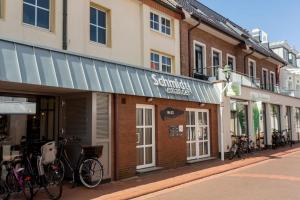 Una hilera de edificios con bicicletas estacionadas en una calle. en Schmidt-einander W 8, en Norderney