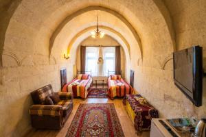 a living room with a couch chairs and a table at Asyada Suites Hotel in Nevsehir