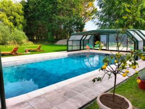 a swimming pool in a yard with a house at La Mouillère in Verton