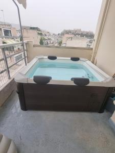 a hot tub on the balcony of a building at athens parthenon view in Athens