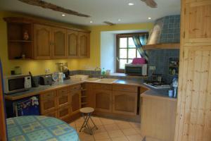 a kitchen with wooden cabinets and a counter top at Pen An Lan in Pleumeur-Bodou
