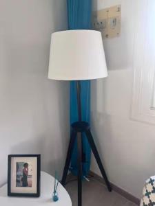 a lamp on a table with a picture in a room at 1-Bed Apt 10 mins to Beach Choose from 4 Pools in San Miguel de Salinas +28 photos