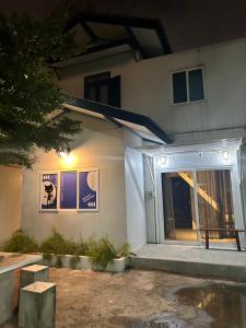 a white house with a window and a door at Cat in the box homestay in Godown +11 photos