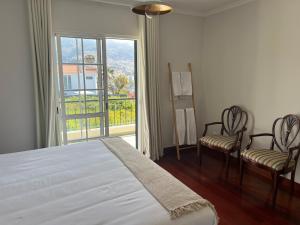 Ένα ή περισσότερα κρεβάτια σε δωμάτιο στο Maribel's Place