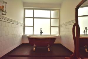 a bath tub in a bathroom with a window at The Tredis Heritage by the Lake in Kodaikānāl