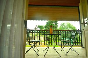 a patio with a table and chairs on a balcony at The Tredis Heritage by the Lake in Kodaikānāl