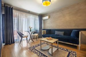 a living room with a blue couch and a table at Lord Morgan & Exclusive Design Residence Nişantaşı in Istanbul