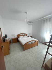 a bedroom with a bed and a white wall at Casa da Aldeia in Moura