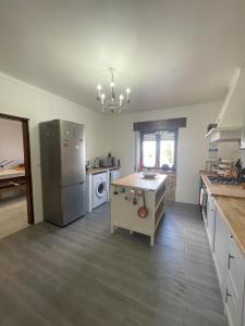 a kitchen with a refrigerator and a table in it at Casa da Aldeia in Moura +14 photos