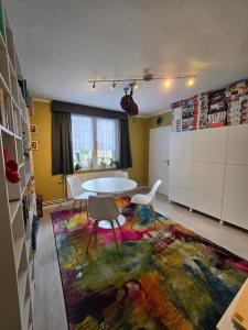 a dining room with a table and chairs on a rug at Casa Andrea in Saint-Vith