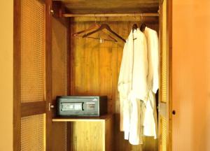 a room with a television and a closet with towels at The Tredis Heritage by the Lake in Kodaikānāl