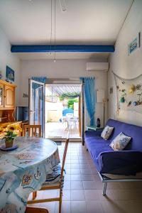 a living room with a table and a couch at La Marina in Saint-Cyprien-Plage