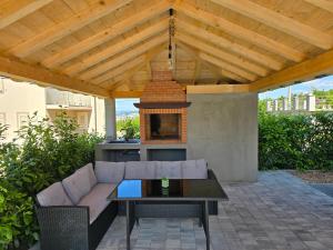 a patio with a couch and a fire place at Luksuzna kuća za odmor "Villa Romantica" in Kraljevica