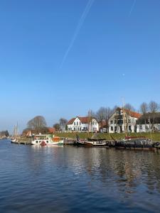 a group of boats docked at a dock on the water at MeerZeit 20 in Carolinensiel