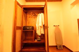 a room with a closet with a treadmill and a door at The Tredis Heritage by the Lake in Kodaikānāl