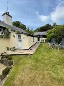 an image of a cottage with a lawn at Frogwell in Strete