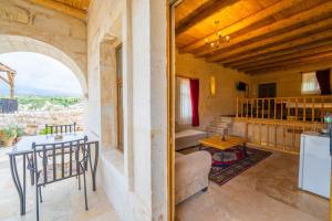 a living room with a table and chairs in a house at Asyada Suites Hotel in Nevsehir