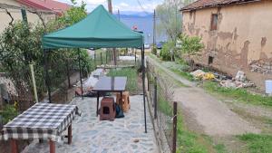 a green tent with a table and a picnic table at Villa Shine apartment 2 in Radožda