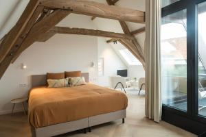 a bedroom with a bed and a large window at NOX Logies, vakantiewoning en polyvalente ruimte in Grimbergen