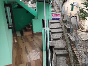 a set of stairs leading up to a building at Yatra Homestay in Joshīmath