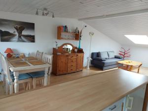 a living room with a table and a blue couch at Flensburg Ferienwohnung Apartment nähe Zentrum und Uni in Flensburg