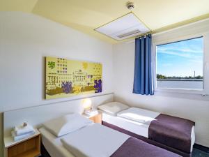 Postel nebo postele na pokoji v ubytování B&B Hotel Braunschweig-Nord