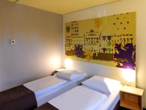 Postel nebo postele na pokoji v ubytování B&B Hotel Braunschweig-Nord
