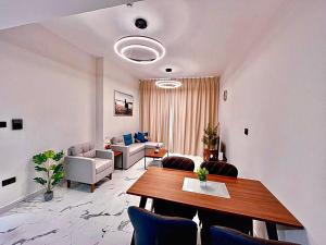 a living room with a table and a couch at 1 Bedroom 1 Min walking to Cleveland and Galleria Mall by Central Stay in Abu Dhabi