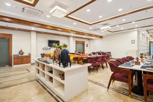 a dining room with a long table and chairs at Padmshree Palace in Ayodhya