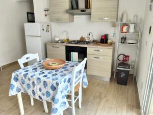 a kitchen with a table with a blue and white table cloth at Casa Mare Ognina in Ognina