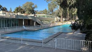 a swimming pool with a slide in front of a building at Lindo departamento vista Club de golf Santo domingo, cerca de parque Tricao in Santo Domingo