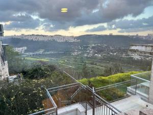 a view of a city from a balcony of a building at Your Home in Mevasseret Zion in Mashabbe Sade