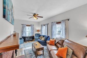 a living room with a couch and a ceiling fan at Cozy Getaway with Hot Tub, Patio & Fenced Yard home in Garfield Heights