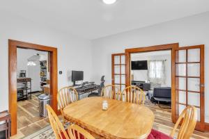 a dining room with a wooden table and chairs at Cozy Getaway with Hot Tub, Patio & Fenced Yard home in Garfield Heights