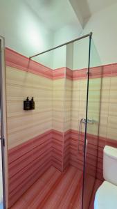 a bathroom with a shower and a toilet at Rida Village Ksamil Island in Ksamil +37 photos