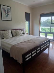 Ένα ή περισσότερα κρεβάτια σε δωμάτιο στο Mission Beach Rural Escape