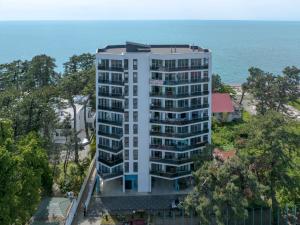 an aerial view of a white building with the ocean in the background at Kobuleti Lounge in Kobuleti