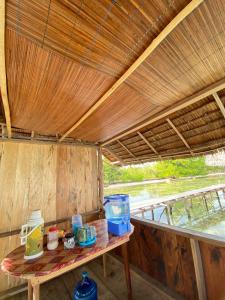 a table in a room with a wooden roof at Senjahomestayrajaampat in Fam